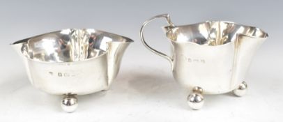 Edward VII hallmarked silver novelty bachelor's milk jug and sugar bowl of trefoil form, raised on
