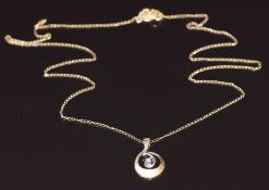 A 14k gold bi-coloured pendant set with a diamond, on 14k gold chain, 1.3g