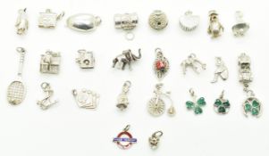 Twenty five silver charms including two enamel shamrocks by WBs, owl, elephant, boat, MG car,