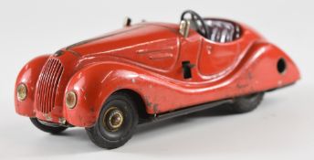 Schuco Examico 4001 clockwork tinplate car with red body and maroon interior.