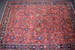 Large Iranian rug with red ground and blue border, 410 x 295cm