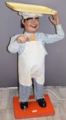 Novelty vintage shop window display advertising automaton model of a baker with tray on his head,