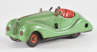 Schucco Examico 4001 clockwork tinplate car with green body and red hubs.