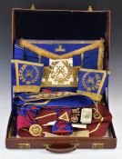 Masonic jewels and aprons in leather carry case, including enamel decorated example, in original
