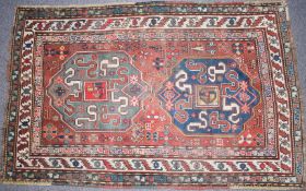 Caucasian Chondzoresk hand woven red ground rug with two central panels and cream border, 200 x