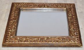Carved wooden framed mirror, overall size 79 x 69cm