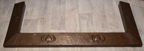 Arts & Crafts copper fire fender with embossed decoration, width 105cm