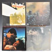 A collection of approximately 60 albums including The Beatles, David Bowie, Don McLean, Cat