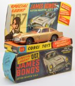 Corgi diecast model James Bond 007 Aston Martin D.B.5 with gold body, red interior, spoked hubs