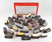 Thirty three 00 gauge model railway mainly goods wagons including brake vans, together with a