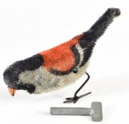 An early 20thC clockwork felt covered toy bird with colours resembling a finch, length 11cm.
