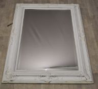 Ornate white painted framed mirror with bevelled glass plate, overall size 117 x 85cm