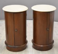 Pair of mahogany circular cupboards with marble tops, height 73 x diameter 41cm