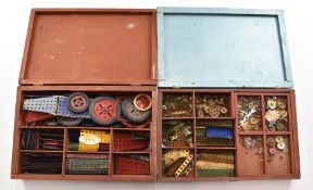 Two cases of Meccano, including wheels, gears and angles