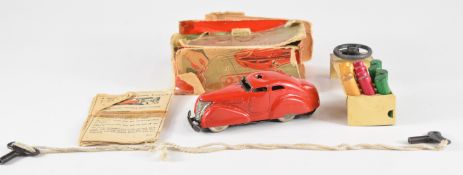 Schuco clockwork tinplate Telesteering Car 3000 with red body, in original box with steering