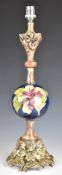 Moorcroft sphere table lamp with giltwood base decorated in the Hibiscus pattern, height 48cm