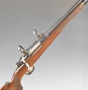 Unnamed .243 bolt-action rifle with chequered semi-pistol grip and forend, raised cheek-piece, sling
