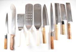Eight Japanese knives / choppers / spatulas, five with signed blades, spatulas by Monogram,