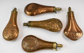 Five copper and brass powder flasks, four with embossed decoration to both sides and one featuring a