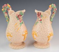 Clarice Cliff pair of pink Celtic Harvest pedestal jugs, height 20cm