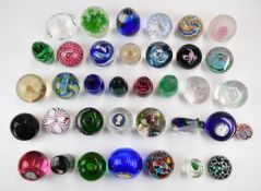 Thirty-seven various glass paperweights including Caithness and Dartington, two in the form of a