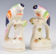 A pair of Staffordshire figural parrot pen or spill holders, height 13.5cm