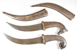 Two Eastern daggers, one with horse's head hilt, the other panther or similar, both having decorated
