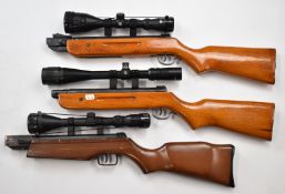 Three various air rifle stocks, all mounted with scopes comprising Nikko Stirling Mountmaster 3-9x50