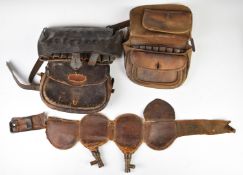 A collection of gun and shooting related items including leather cartridge bags, leather shot belt