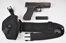 Cyma CM 030 airsoft pistol with textured grip and multi-shot magazine, NVSN, in belt and holster.