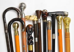 Twelve walking sticks / canes including several silver mounted examples, carved, malacca and