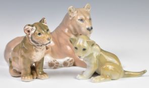 Copenhagen figure of a recumbent lioness and two cubs, tallest 16cm