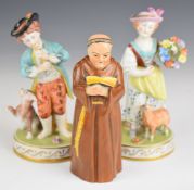 Two Dresden figures and a Royal Worcester monk candle snuffer, tallest 13.5cm