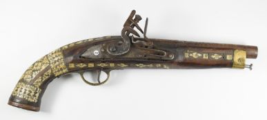 Eastern flintlock military style pistol with bone inlaid decoration, brass trigger guard and