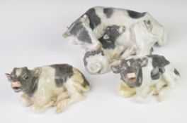 Copenhagen three porcelain recumbent cow / calf figures, largest length 27cm x height 11cm