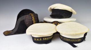 Five Royal Navy hats comprising a bicorn retailed by Gieves Ltd London, two officer's plastic caps