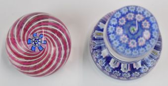 Two John Deacons glass paperweights, one in the form of a inkwell with signature thistle cane to the