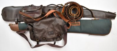 A collection of shotgun accessories comprising two padded or wool lined gun slips, a leather