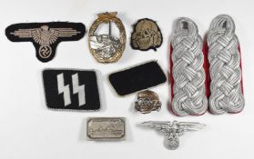 Replica German Third Reich Nazi badges together with a pair of shoulder boards and a Kriegsmarine