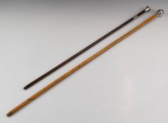 Two military style swagger sticks, one with hallmarked silver pommel the other with 'Two Bears and a