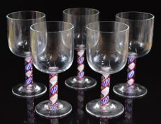 A set of five Steve Bradley drinking glasses with red, white and blue coloured twist stems, signed