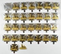 Twenty nine Royal Gloucestershire, Berkshire & Wiltshire Regiment forage cap badges by London