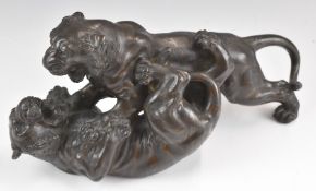 Japanese bronze of two tigers fighting with impressed mark to base, length 32 x height 15cm