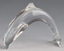Baccarat glass leaping dolphin paperweight with etched logo to tail, 12cm long.