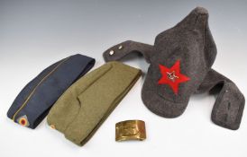 Three Cold War Eastern Bloc hats and a Russian felt example with collar protection and badge,