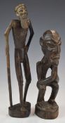 Two African carved tribal figures including an elder with stick, tallest 32cm