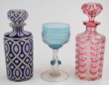 Two overlaid glass scent bottles, one Baccarat style cranberry over clear ground together with a