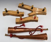 A pair of copper hunting horns (43cm long) together with three coat racks in the form of shotgun