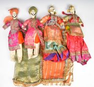 Four early 20thC Indian dolls wearing traditional costumes and high grade miniature gold