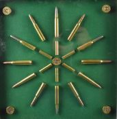 A rifle and shotgun cartridge display board with twenty-three brass cartridges and cartridge caps